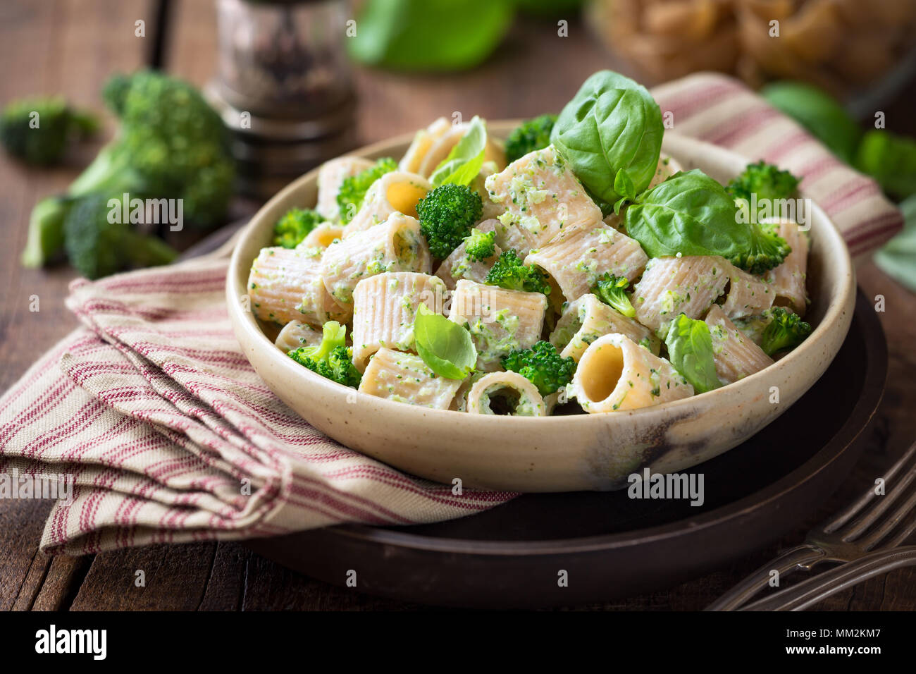 Vegetarian whole grain pasta with creamy broccoli sauce and basil Stock