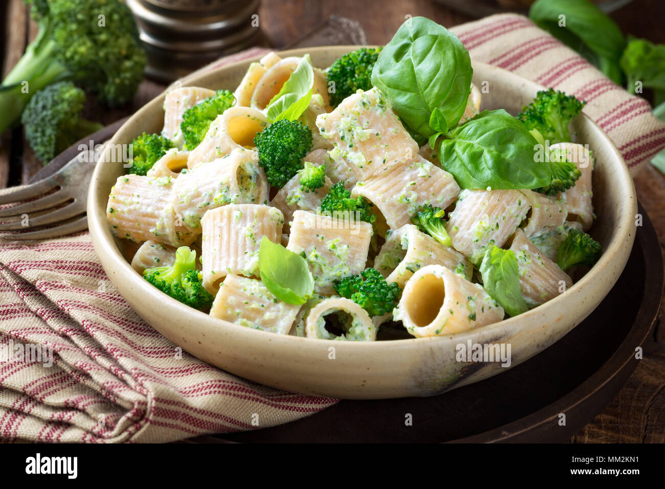 Vegetarian whole grain pasta with creamy broccoli sauce and basil Stock