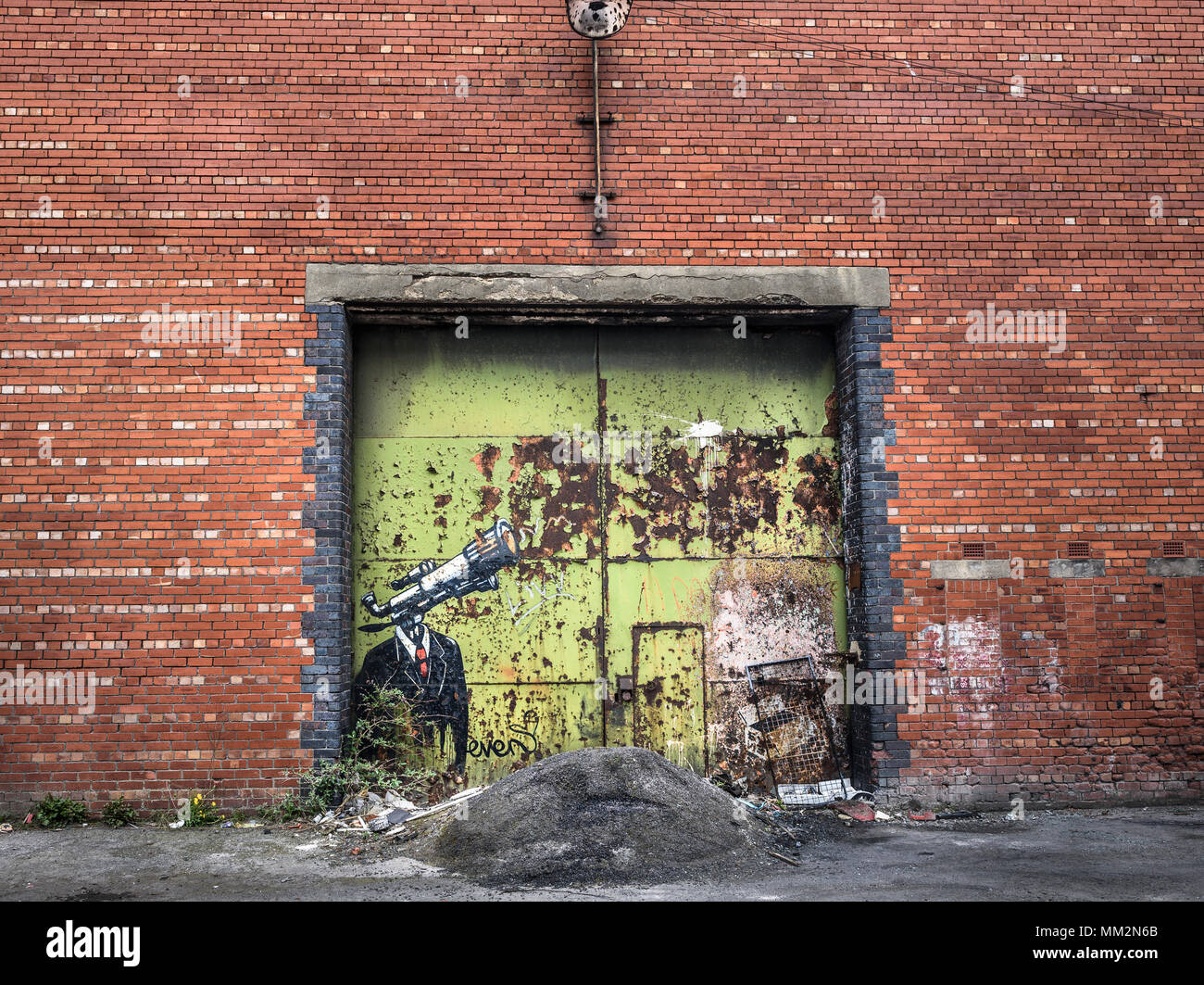 Abandoned brick warehouse with rusty iron doors. Stock Photo
