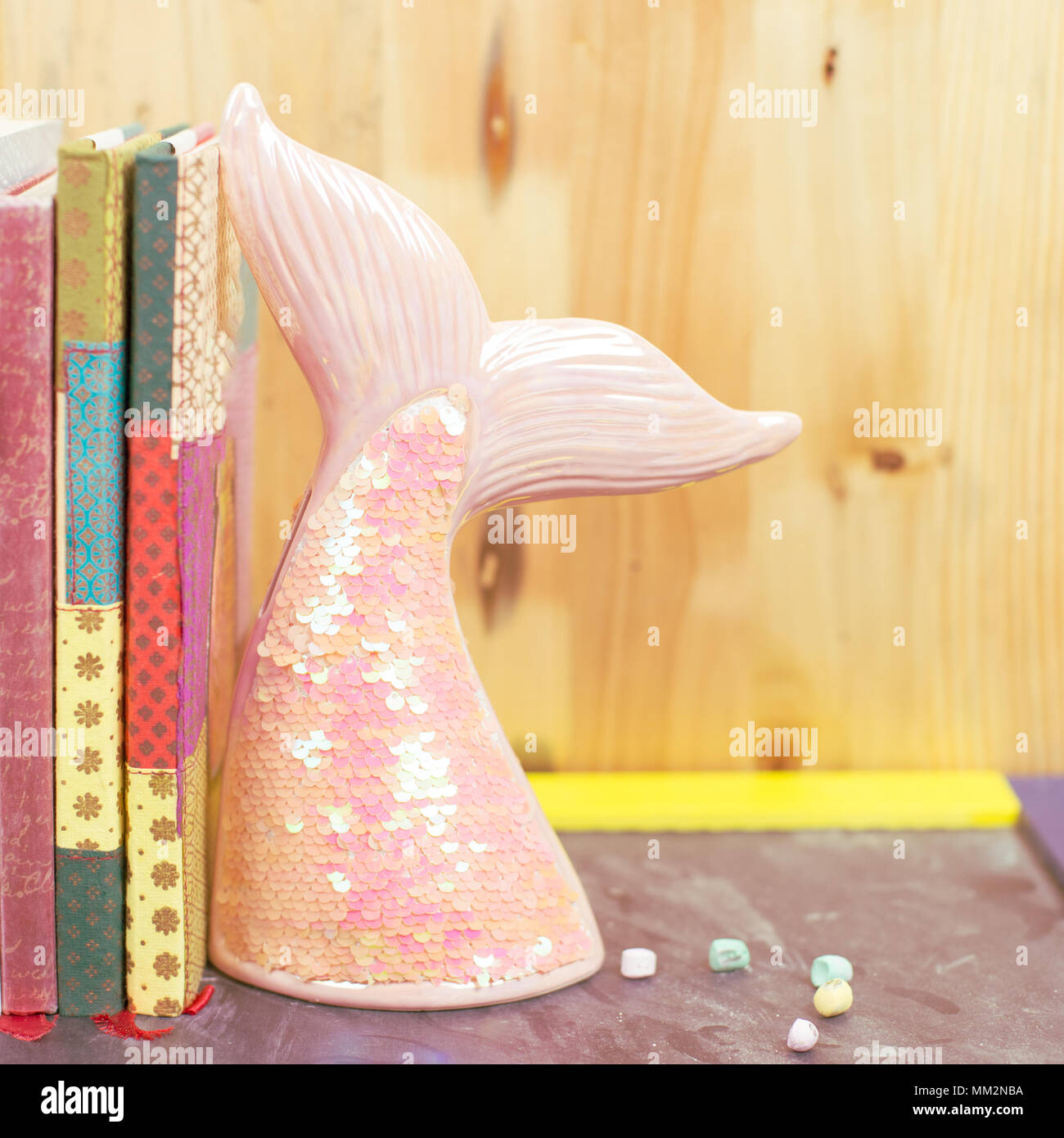 Back to school trend concept with book shelf and mermaid tail Stock Photo