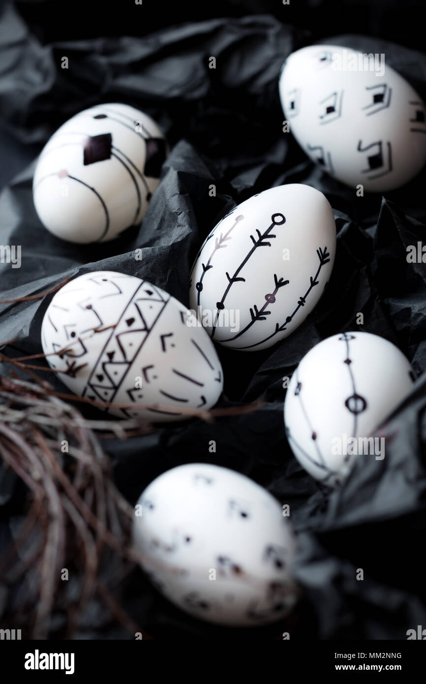 Black and white Nordic style inspired decorated Easter eggs on black Stock Photo
