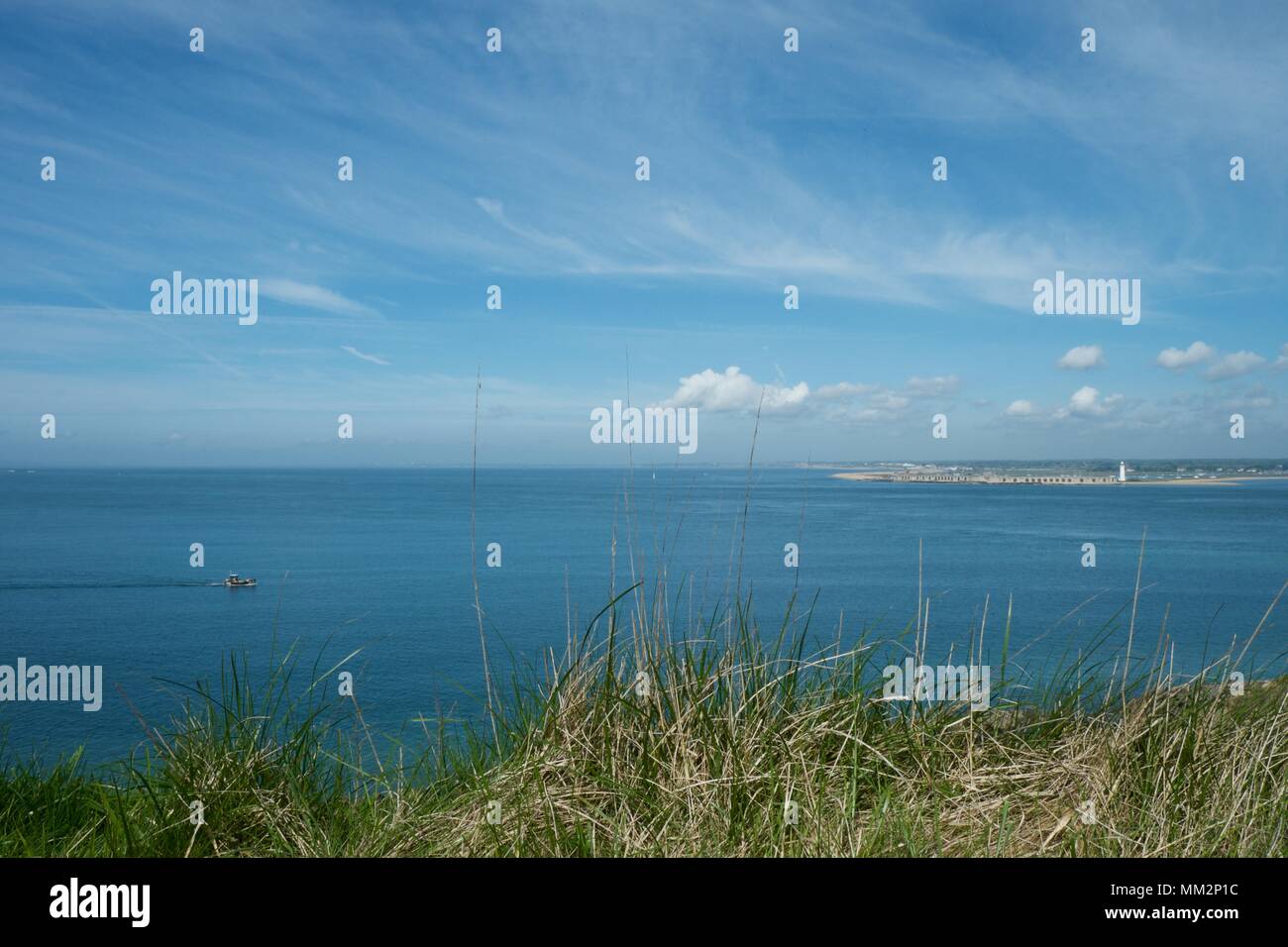 looking across the Solent towards Hurst Castle from Colwell Bay, Isle of Wight, UK on a sunny day with light cloud Stock Photo