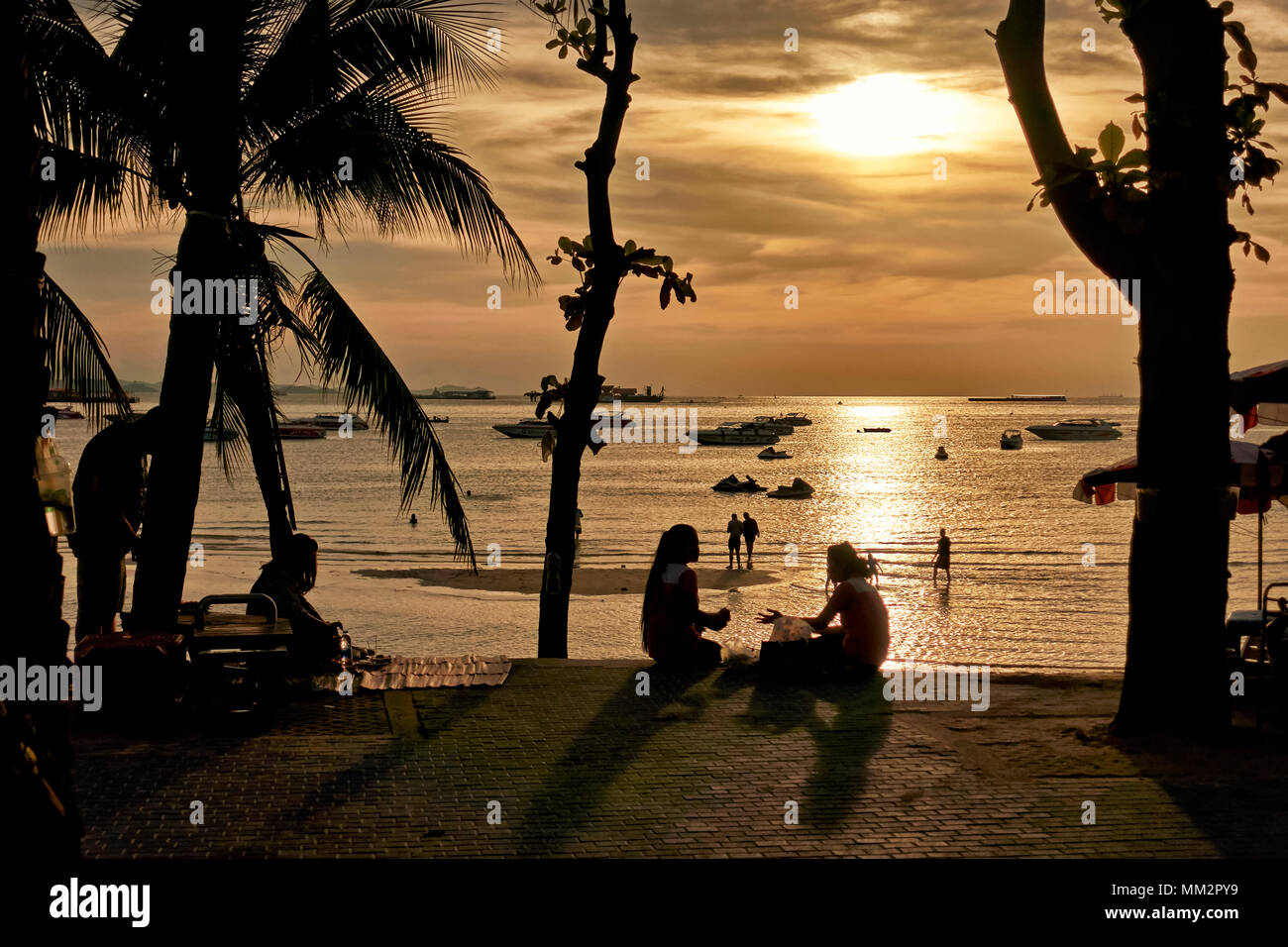 Tropical Sunset at Pattaya beach with people overlooking the Ocean. Thailand, Southeast Asia Stock Photo