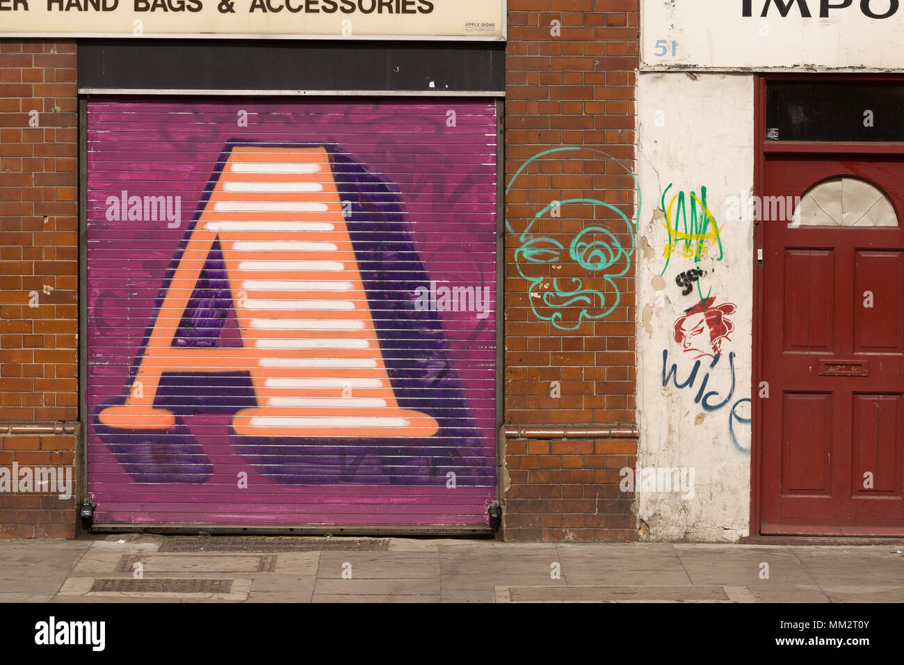 Street Art, by Street Artist 'Eine', who paints gaint letters on shop window shutters, Hackney Road, London, E2, Britain. Stock Photo