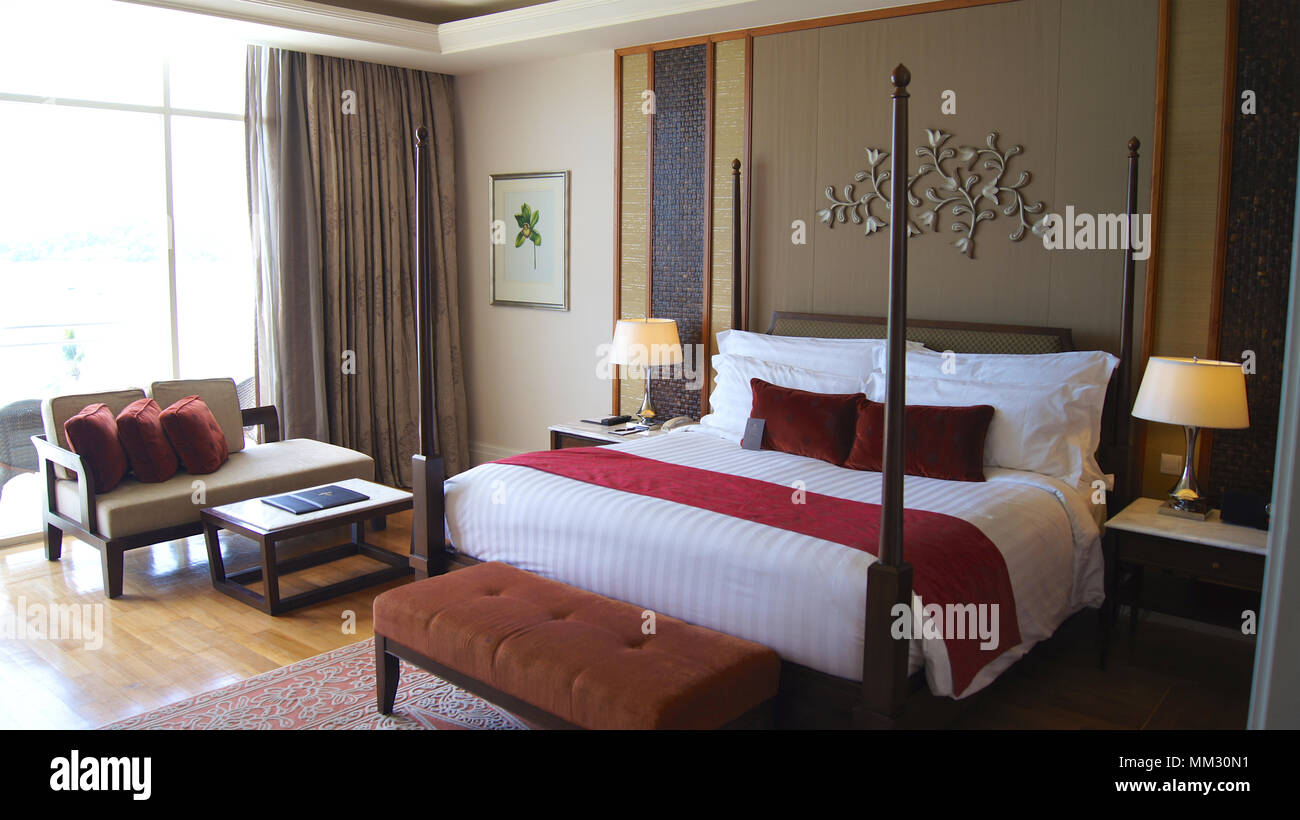 PULAU LANGKAWI, MALAYSIA - APR 4th 2015: Comfy bed in a luxury hotel suite at THE DANNA, colonial room design. Stock Photo