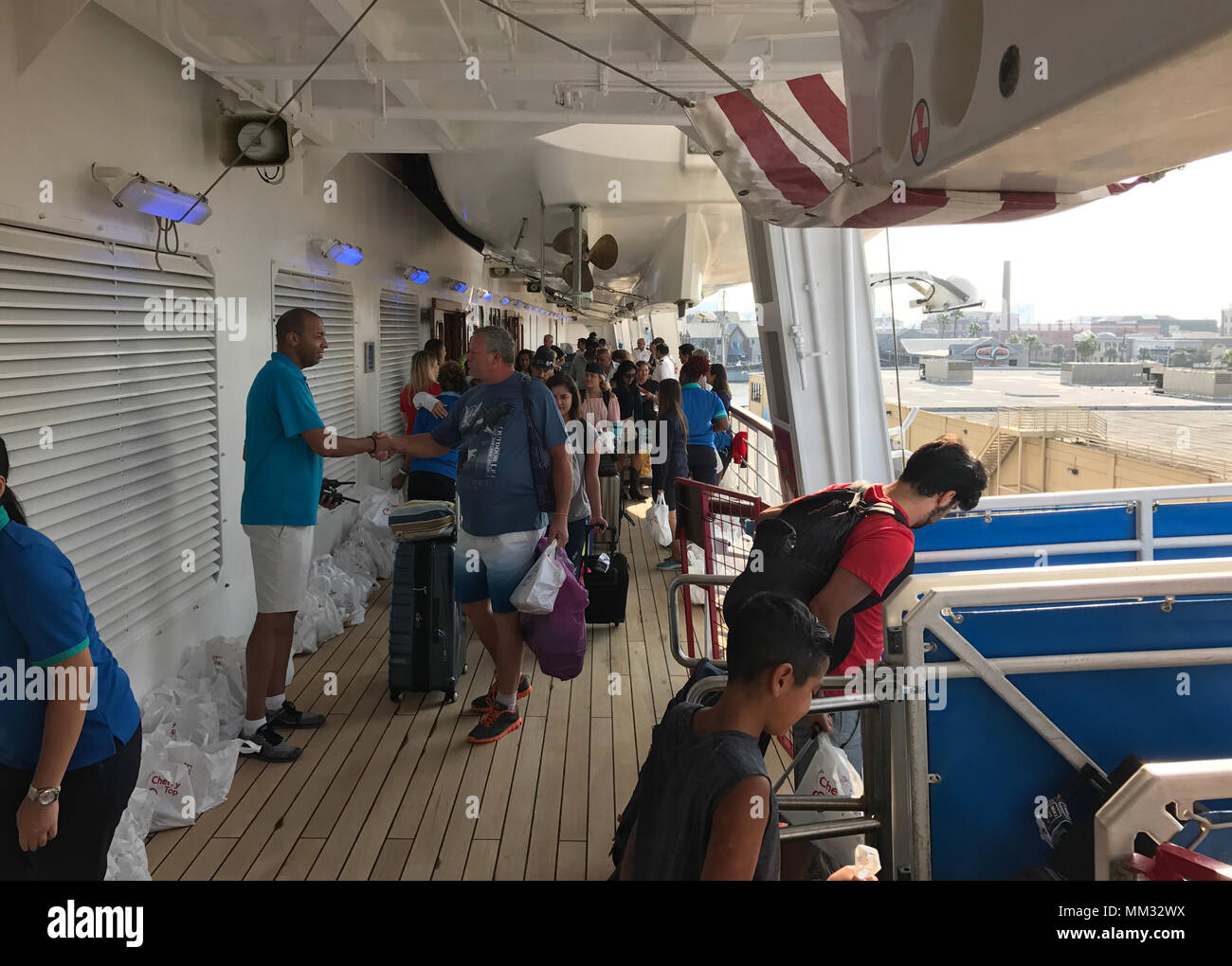 Passengers aboard the Carnival cruise ship Freedom disembark in Galveston, Texas, Sept. 1, 2017. The passengers were stranded at sea for an additional six days due to Hurricane Harvey. (U.S. Coast Guard photo by Petty Officer 2nd Class Jonathan Klingenberg/Released) Stock Photo