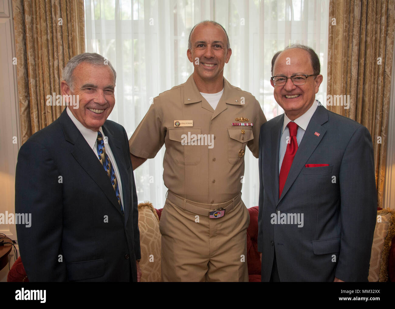 LOS ANGELES (Sept. 1, 2017) (from left to right) Edward P. Roski Jr., University of Southern California's chairman of the board, Rear Adm. Cathal S. O’Connor, commander, Expeditionary Strike Group THREE, and Dr. C. L. Max Nikias, president of the University of Southern California, pose for a photo during a meeting held in conjunction with the second annual Los Angeles Fleet Week. LA Fleet Week is an opportunity for the American public to meet their Navy, Marine Corps and Coast Guard team and experience America's sea services. During fleet week, service members will participate in various commu Stock Photo