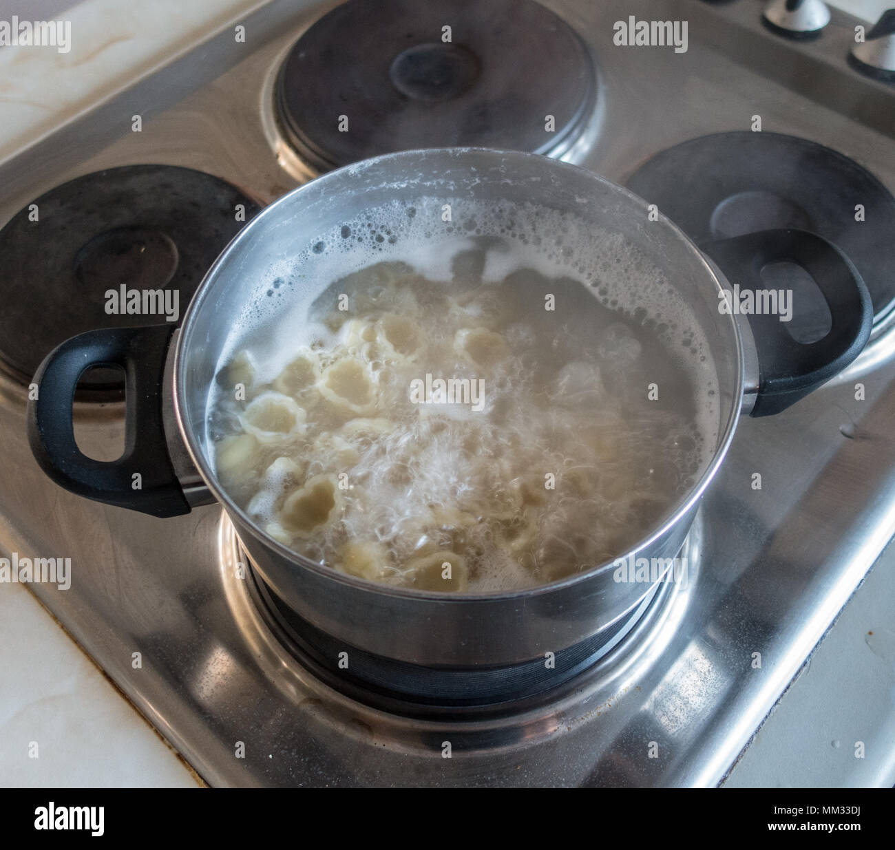 Pasta boiling on an oven hob Stock Photo Alamy