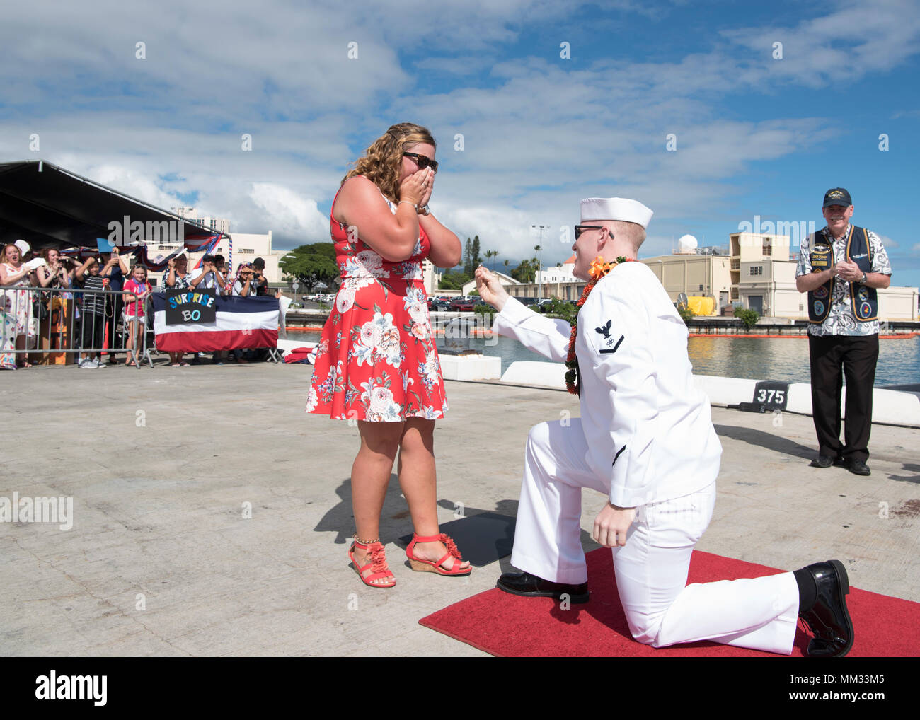 170901-N-KV911-0011 PEARL HARBOR Petty Officer 3rd Class Michael Dodge proposes to his girlfriend Samantha Mills after the Los Angeles-class attack submarine USS Columbus (SSN 762) made its homecoming arrival at Joint Base Pearl Harbor-Hickam, after completing its latest deployment, Sep. 1. Columbus is equipped with vertical launch system for Tomahawk cruise missiles and an improved hull design for under-ice operations.(U.S. Navy Photo by Mass Communication Specialist 2nd Class Shaun Griffin/Released) Stock Photo