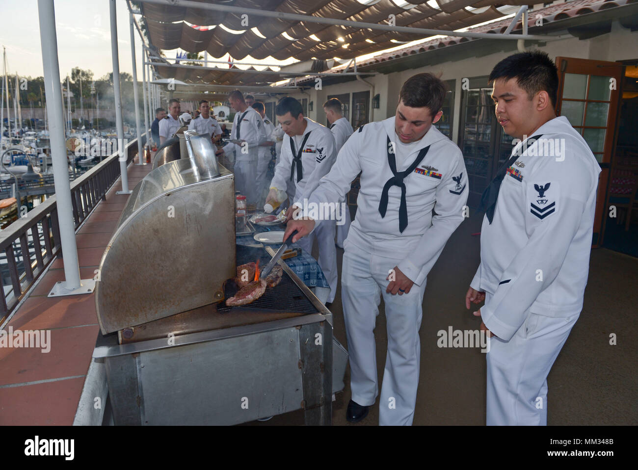 LOS ANGELES (Sept. 1, 2017) Sailors barbecue steaks while attending a dinner party at the Cabrillo Beach Yacht Club during the second annual Los Angeles Fleet Week. LA Fleet Week is an opportunity for the American public to meet their Navy, Marine Corps and Coast Guard team and experience America's sea services. During fleet week, service members will participate in various community service events, showcase capabilities and equipment to the community, and enjoy the hospitality Los Angeles and surrounding areas have to offer. (U.S. Navy photo by Mass Communication Specialist 2nd Class Derek Ha Stock Photo