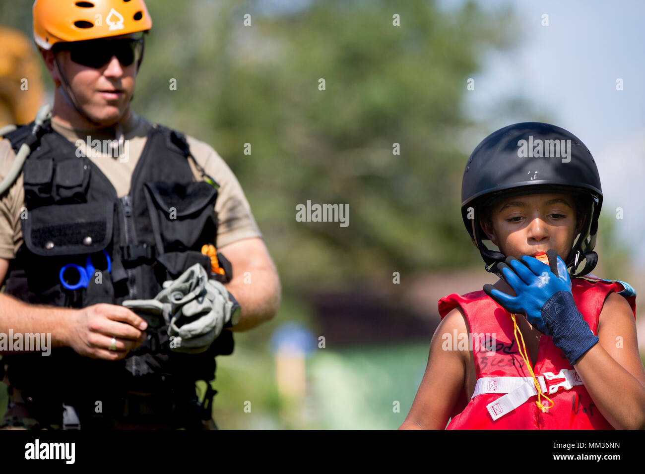 A flood victim blows a whistle given to him by U.S. Army Sgt. Jessie Fergeson  in Orange, Texas, Sept. 4, 2017. U.S. Military and relief agencies continue to assist those affected by Hurricane Harvey. (U.S. Army photo by Staff Sgt. Carl Greenwell) Stock Photo