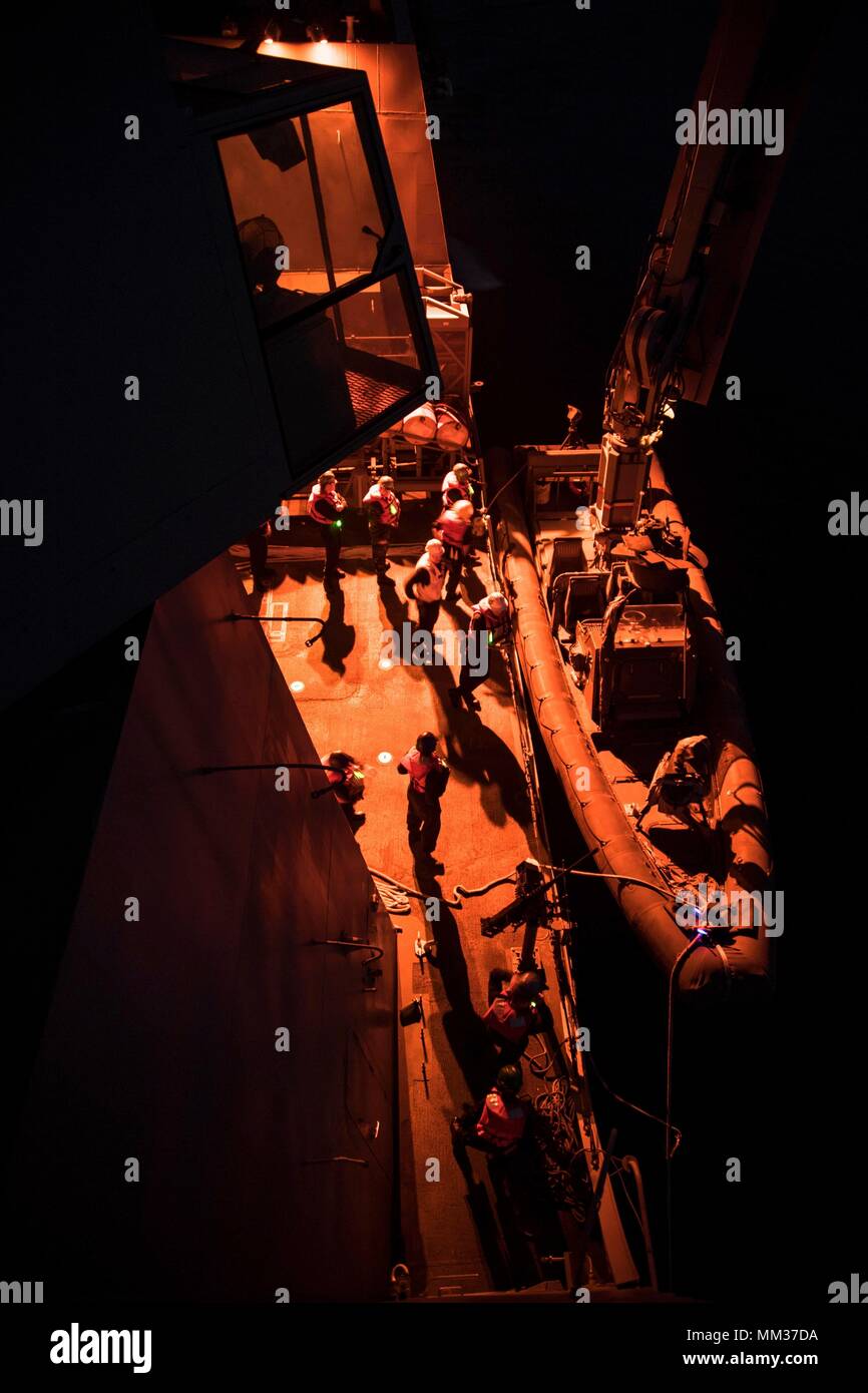 U.S. 5TH FLEET AREA OF OPERATIONS (Sept. 04, 2017) Sailors assigned to the deck department aboard the amphibious transport dock ship USS San Diego (LPD 22) conducts boat operations on the ship’s boat deck during Alligator Dagger exercise. Alligator Dagger is a dedicated, unilateral combat rehearsal led by Naval Amphibious Force, Task Force 51/5th Marine Expeditionary Brigade, in which combined Navy and Marine Corps units of the America Amphibious Ready Group and embarked 15th Marine Expeditionary Unit are to practice, rehearse and exercise integrated capabilities that are available to U.S. Cen Stock Photo