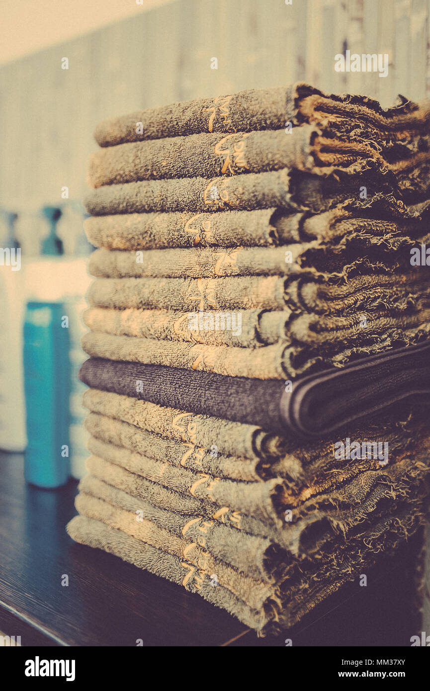 Stack of bath towels on wooden background close up. Toned image. A stack of clean towels Stock Photo