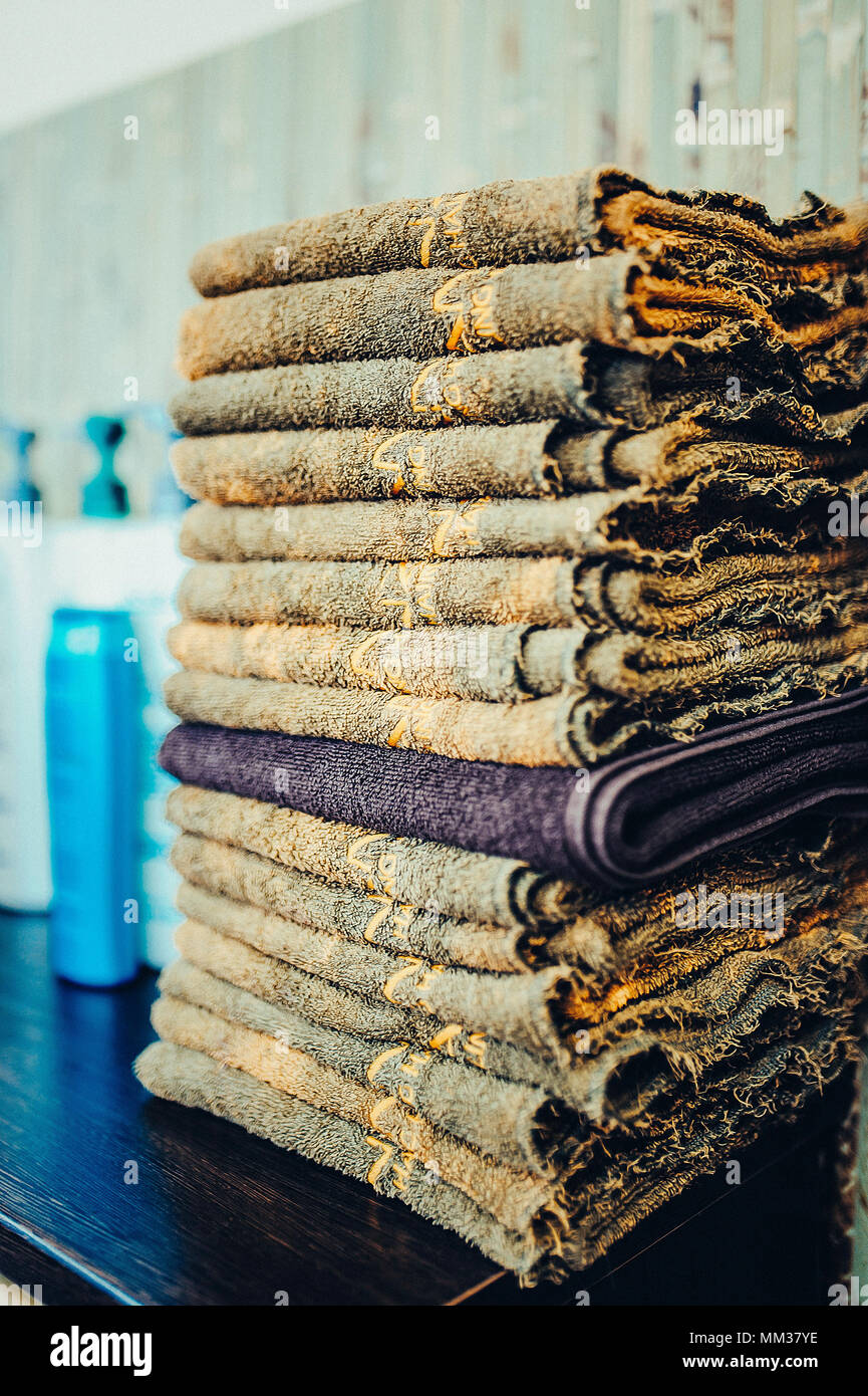 Stack of bath towels on wooden background close up. Toned image. A stack of clean towels Stock Photo