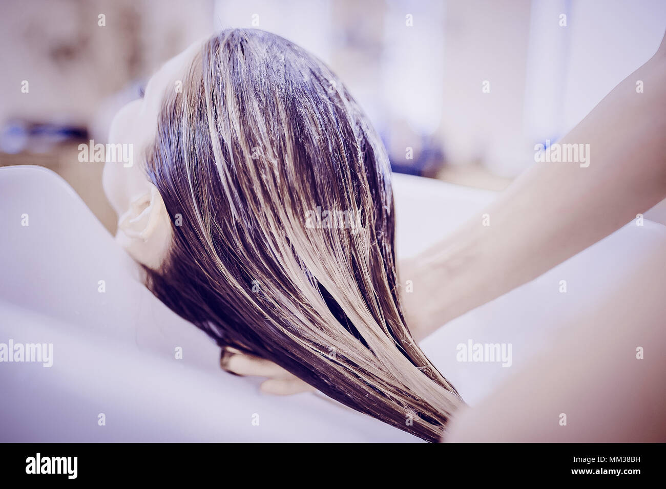 girl in a beauty salon. wash your hair, hair care, health. Toned image. Process of washing your hair in a hairdresser Stock Photo