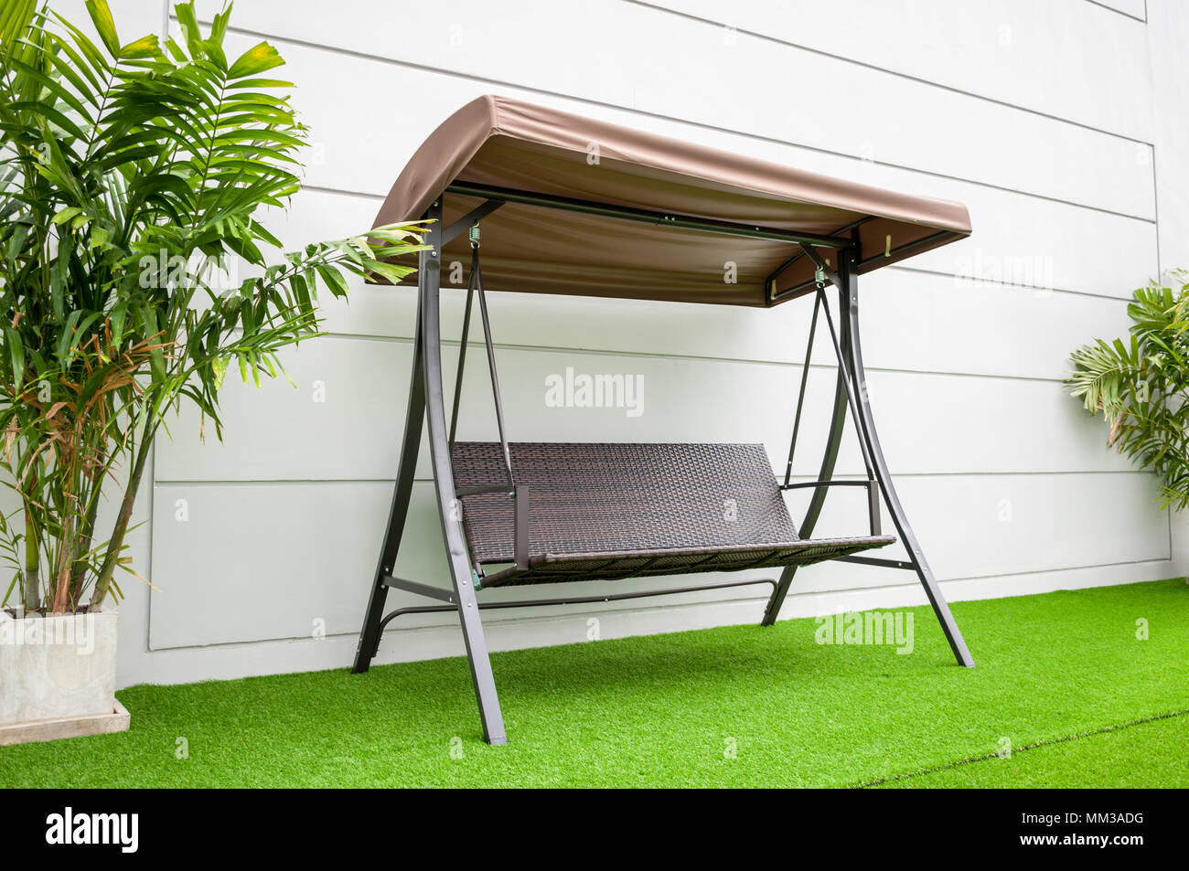 Steel brown swing chair modern style on white concrete wall background