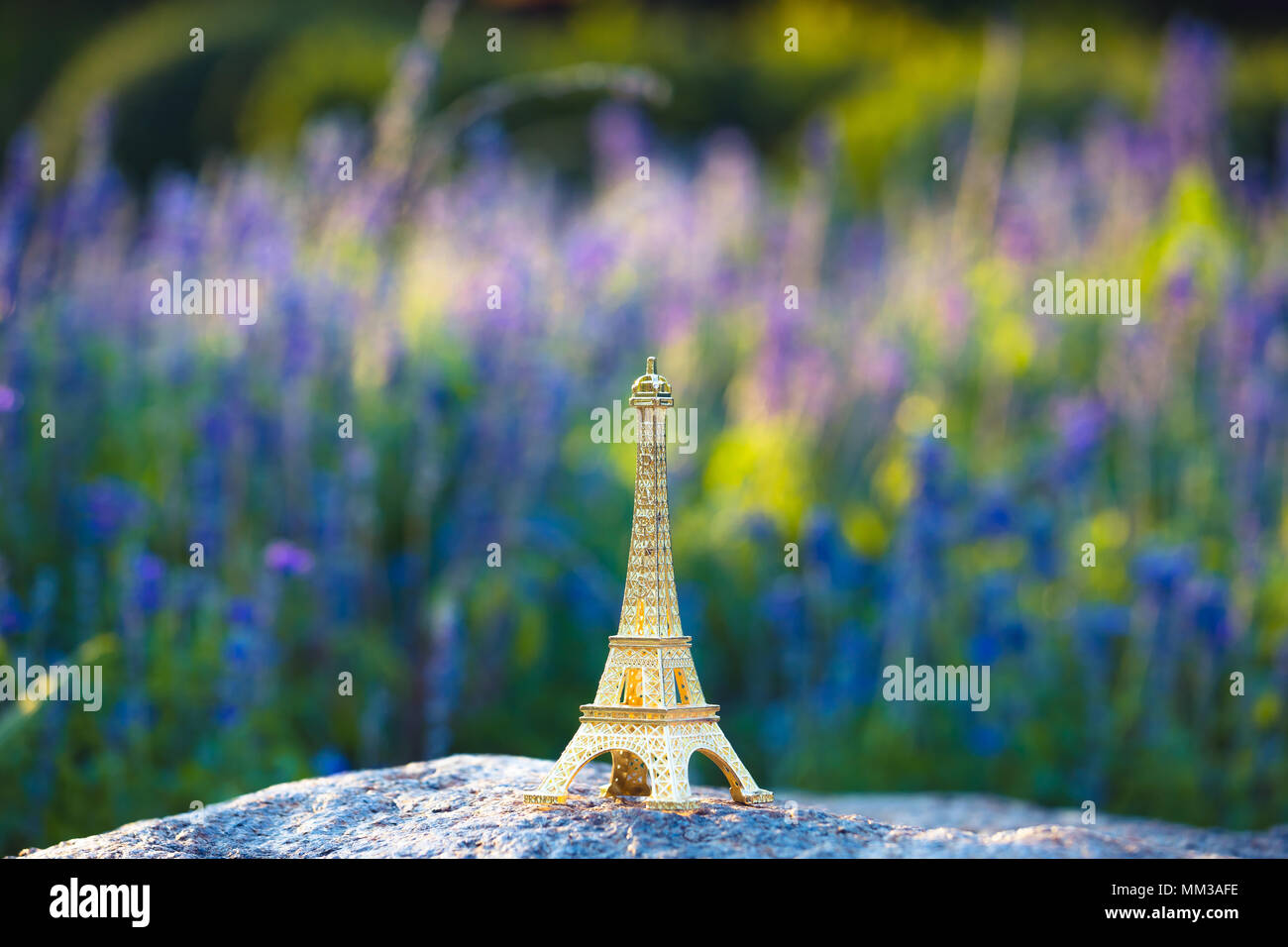 miniaturized eiffel tower with lavander fields in background in day . french culture . Stock Photo