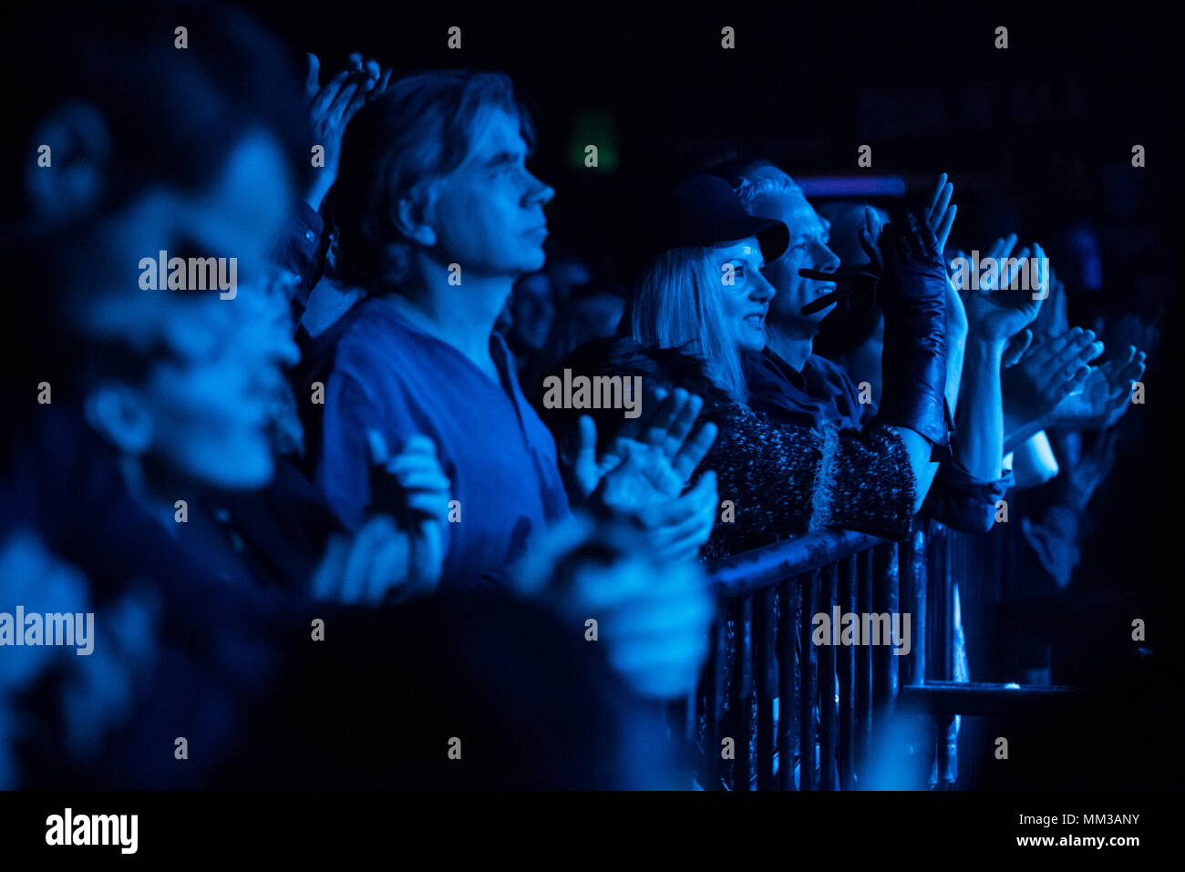 Ecstatic audience at rock concert at night Stock Photo