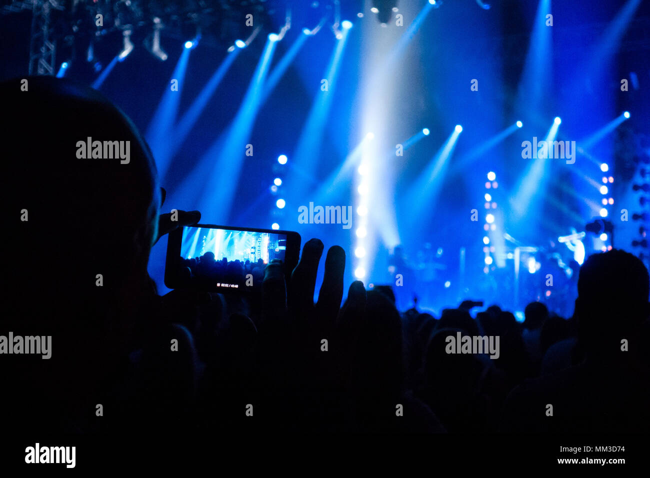 Concert Fans Camera Unrecognizable fan filming a video of a music live concert with his ...