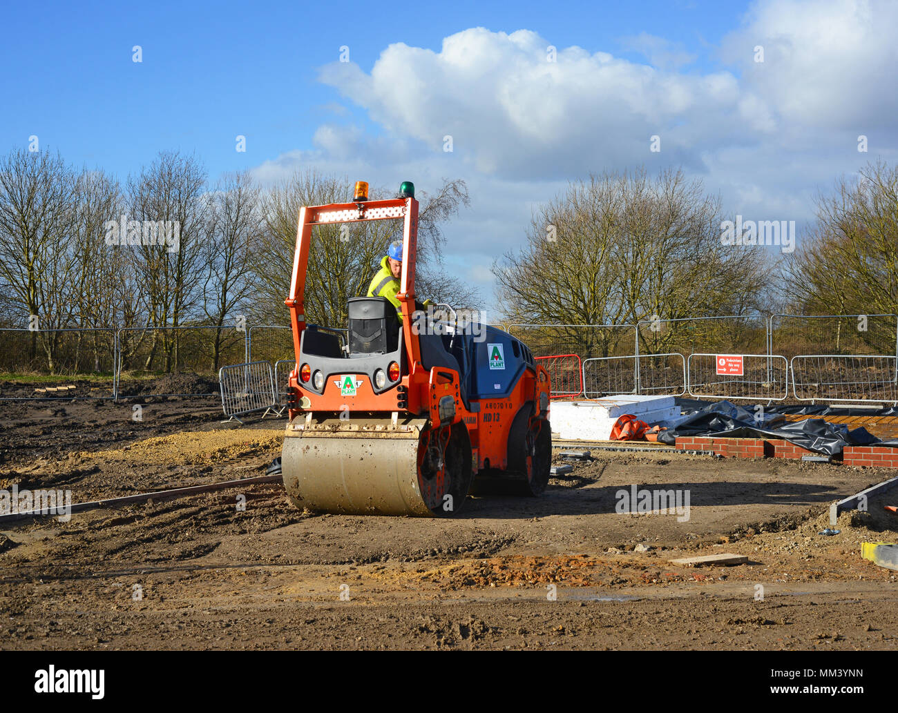 roller compacting soil preparing ground for new house construction barley fields selby yorkshire united kingdom Stock Photo