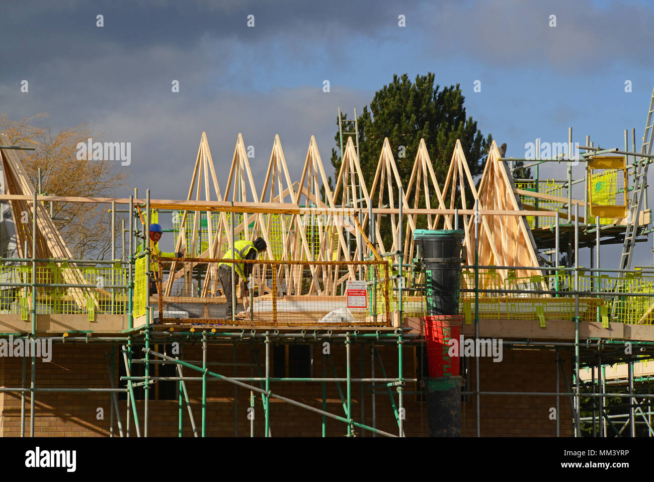 construction workers assembling roof trusses on new build house selby yorkshire united kingdom Stock Photo