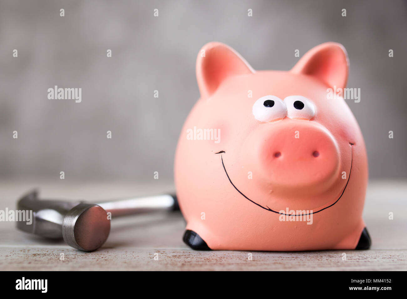 Man holding a piggy bank Stock Photo - Alamy