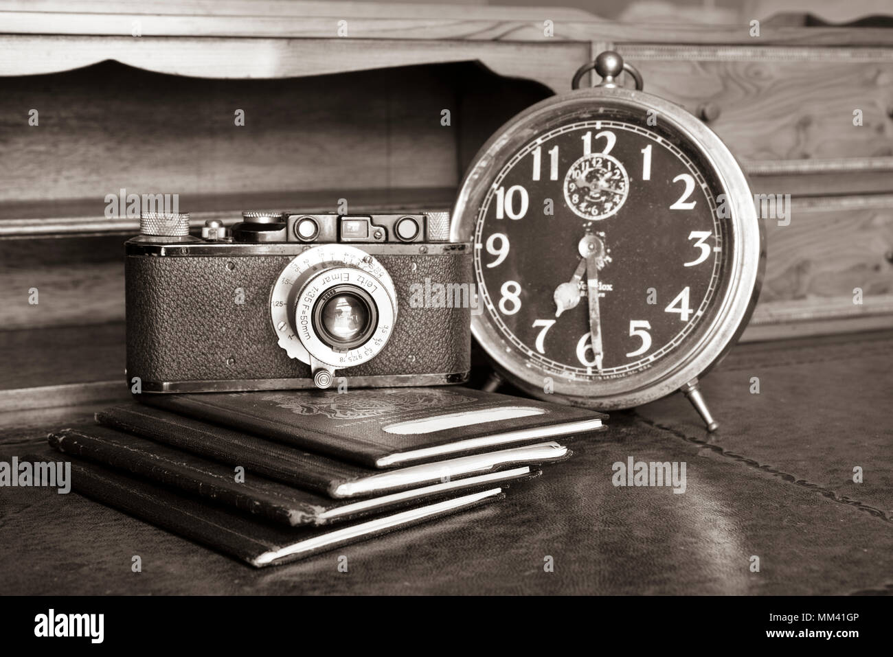 antique timber desk with passports and vintage leica II from 1932