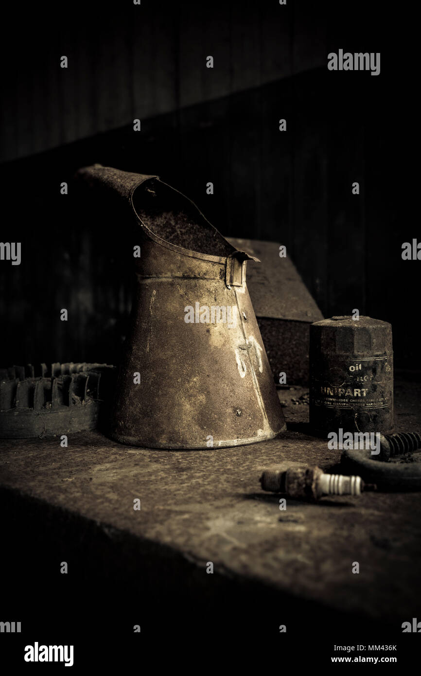 old rusty oil cans in garage Stock Photo
