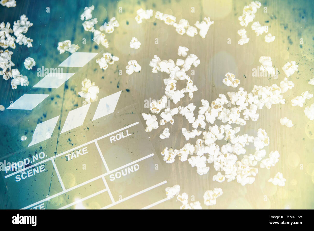 Popcorn and clapperboard on colorful blue background Stock Photo