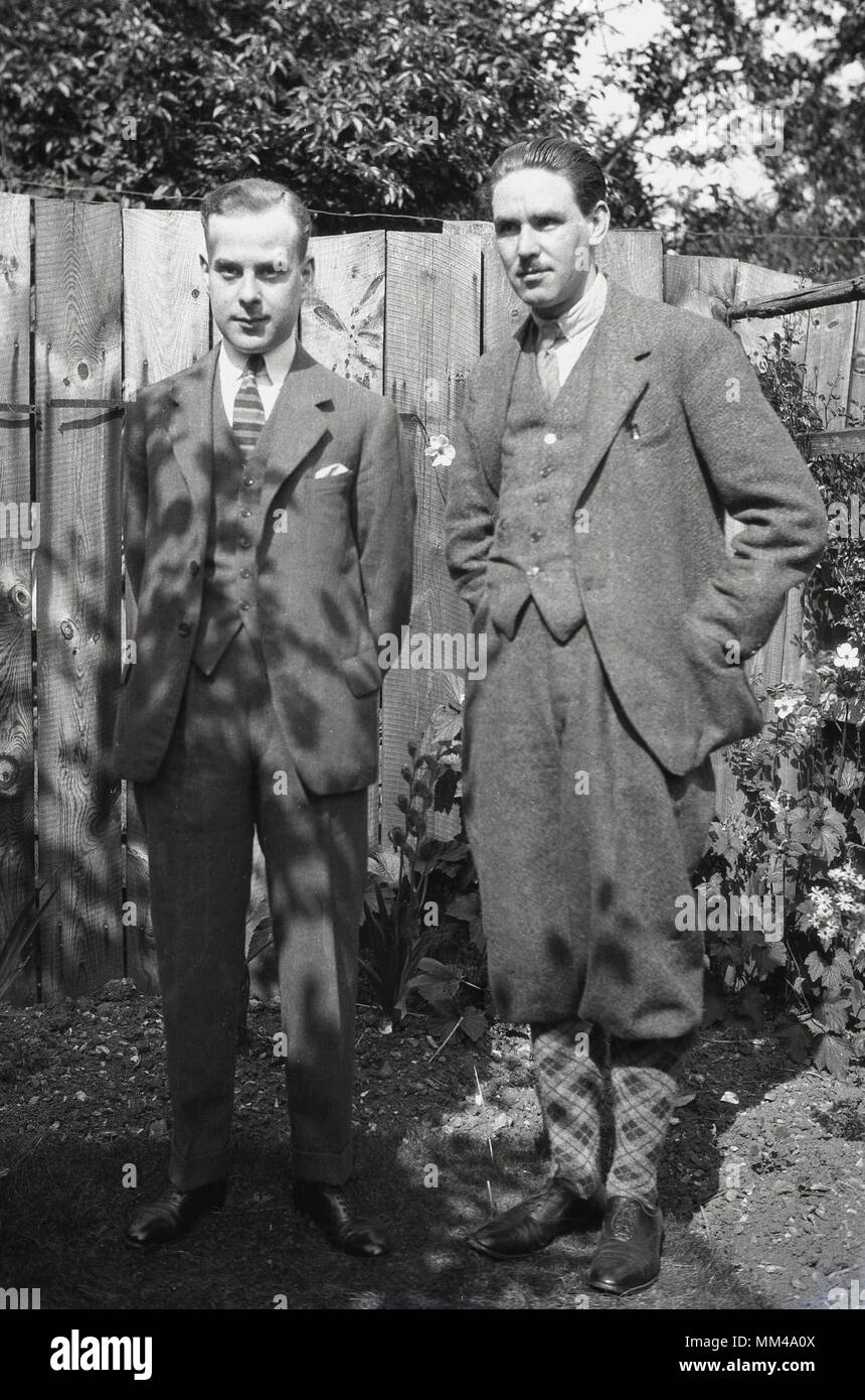 1930s, historical, two well-dressed English gentlemen stand in a back garden wearing the male fashions of the day, England, uk. Stock Photo