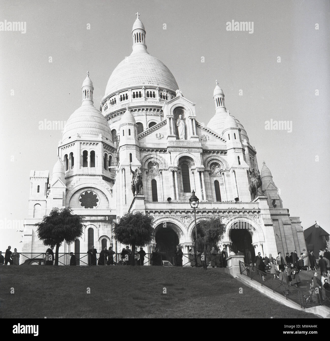 1950s, historical picture of the Basilica of the Sacred Heart of Paris, more commonly known simply as Sacre-Coeur a Roman Catholic built on top of the hill of Montmartre, Paris, France.