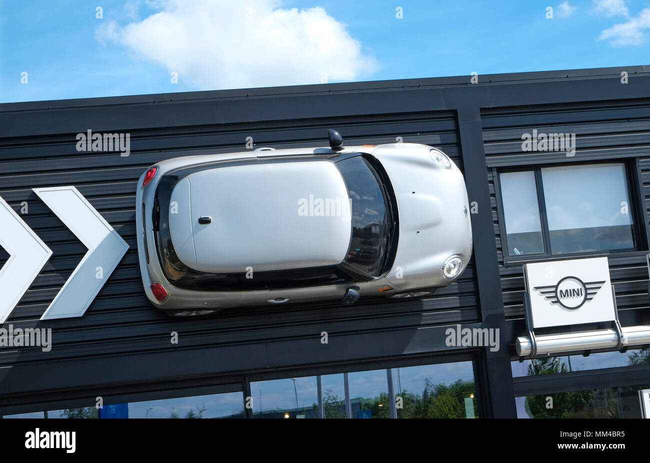 mini car fixed to wall at dealership, king's lynn, norfolk, england Stock Photo