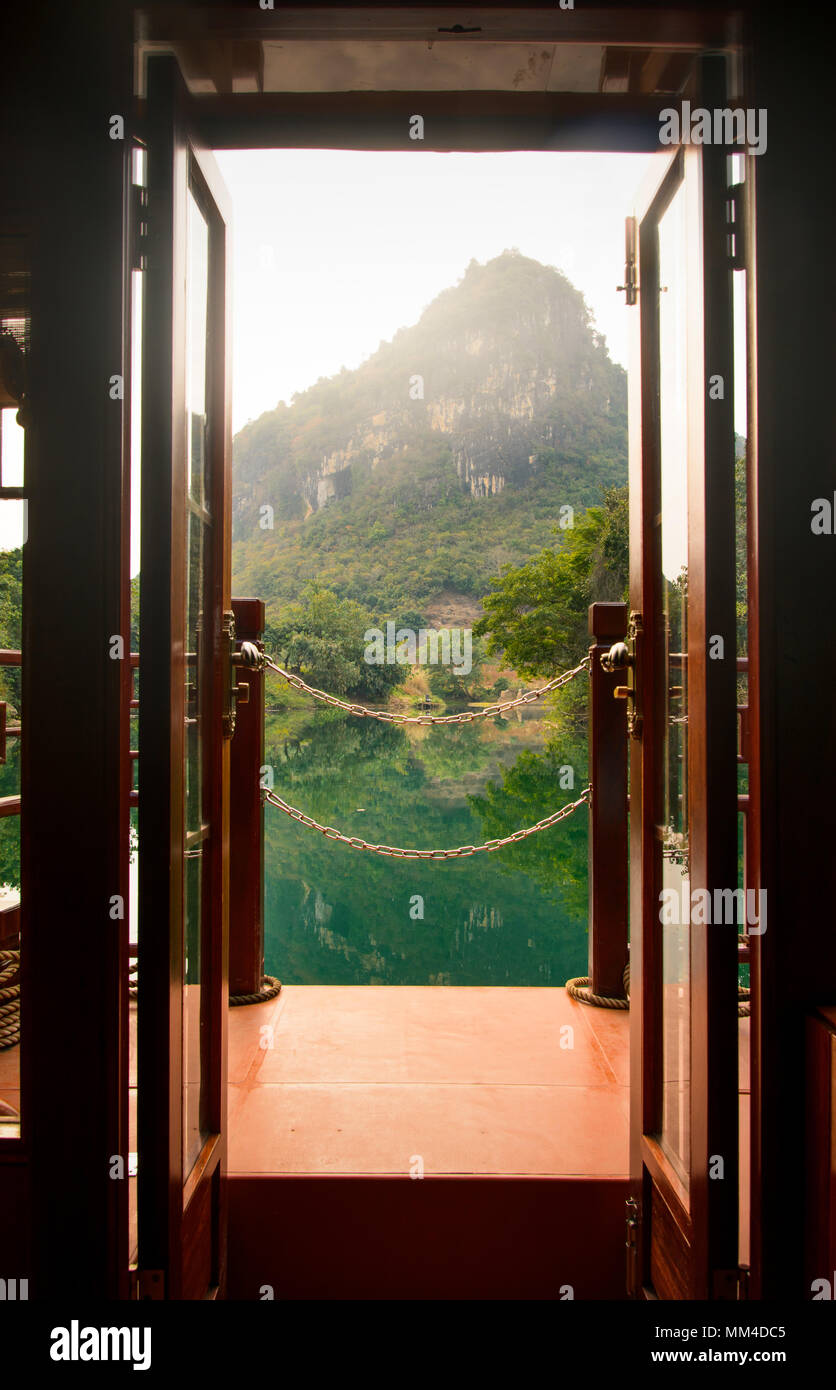 Sunset view through boat door over a lake in Guangxi, China Stock Photo