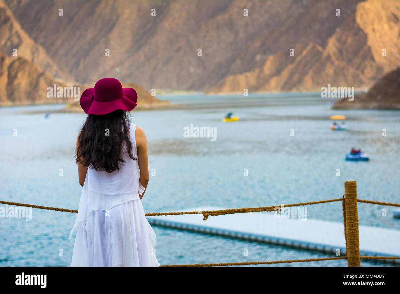 Woman enjoying Hatta Dam Lake scenery in eastern Dubai, United Arab Emirates Stock Photo