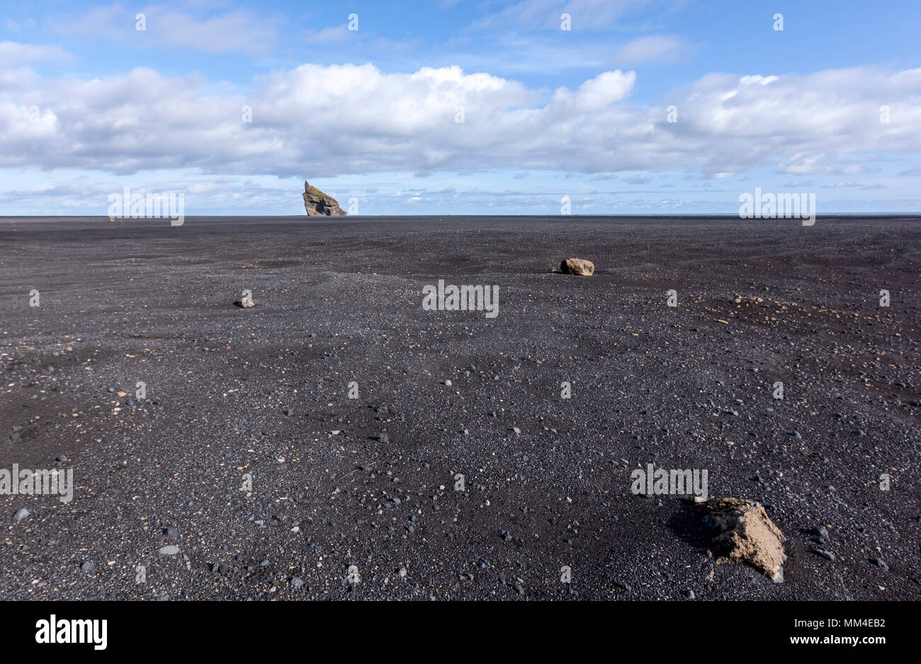 Isolated rock in black sand beach in Mýrdalssandur, Iceland Stock Photo