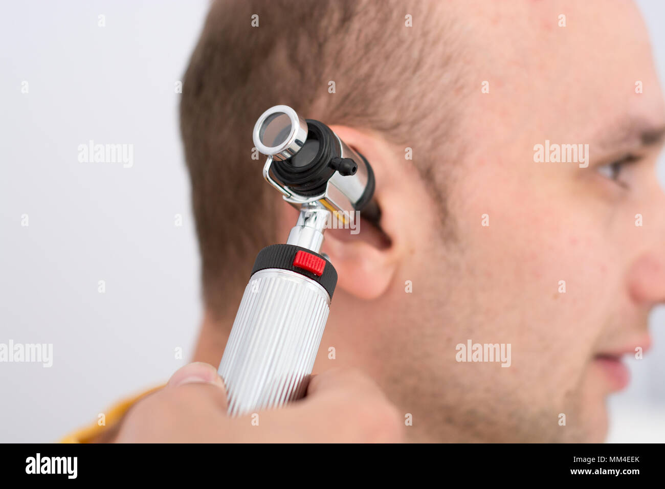 Doctor examining patients ear in doctors office Stock Photo Alamy