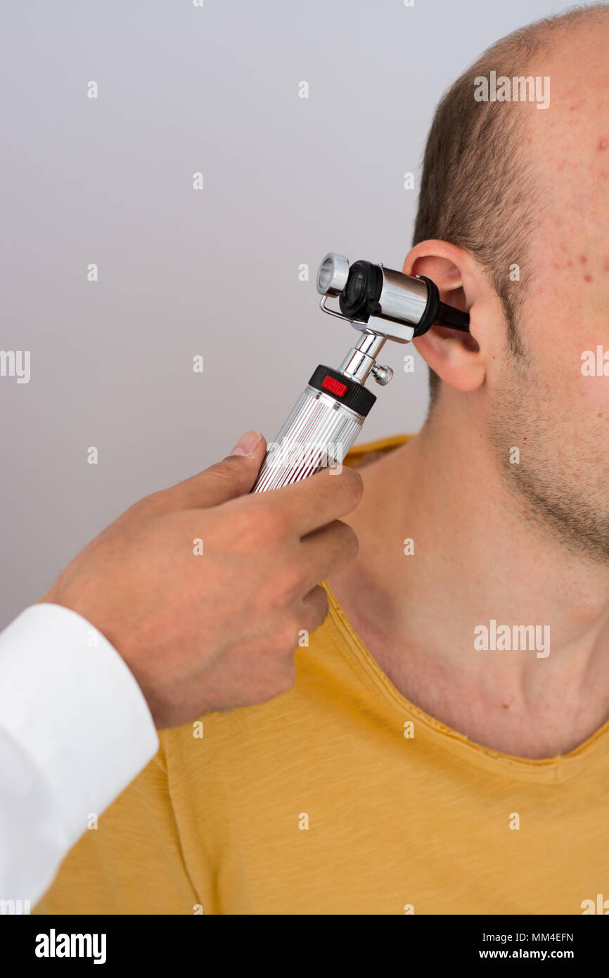 Doctor examining patients ear in doctors office Stock Photo Alamy
