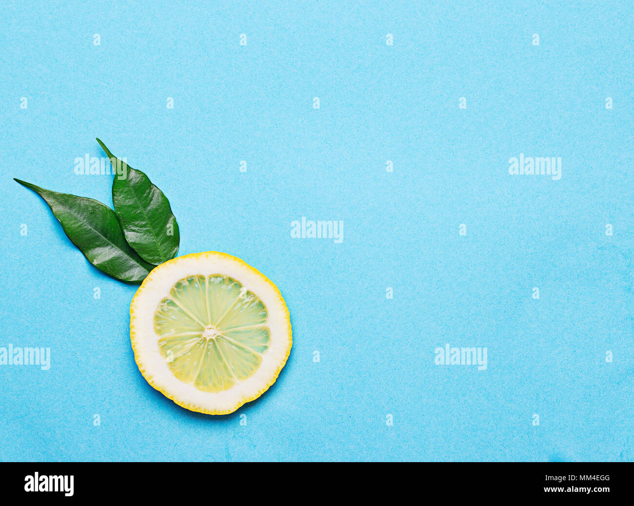 Sliced lemon on blue background Stock Photo