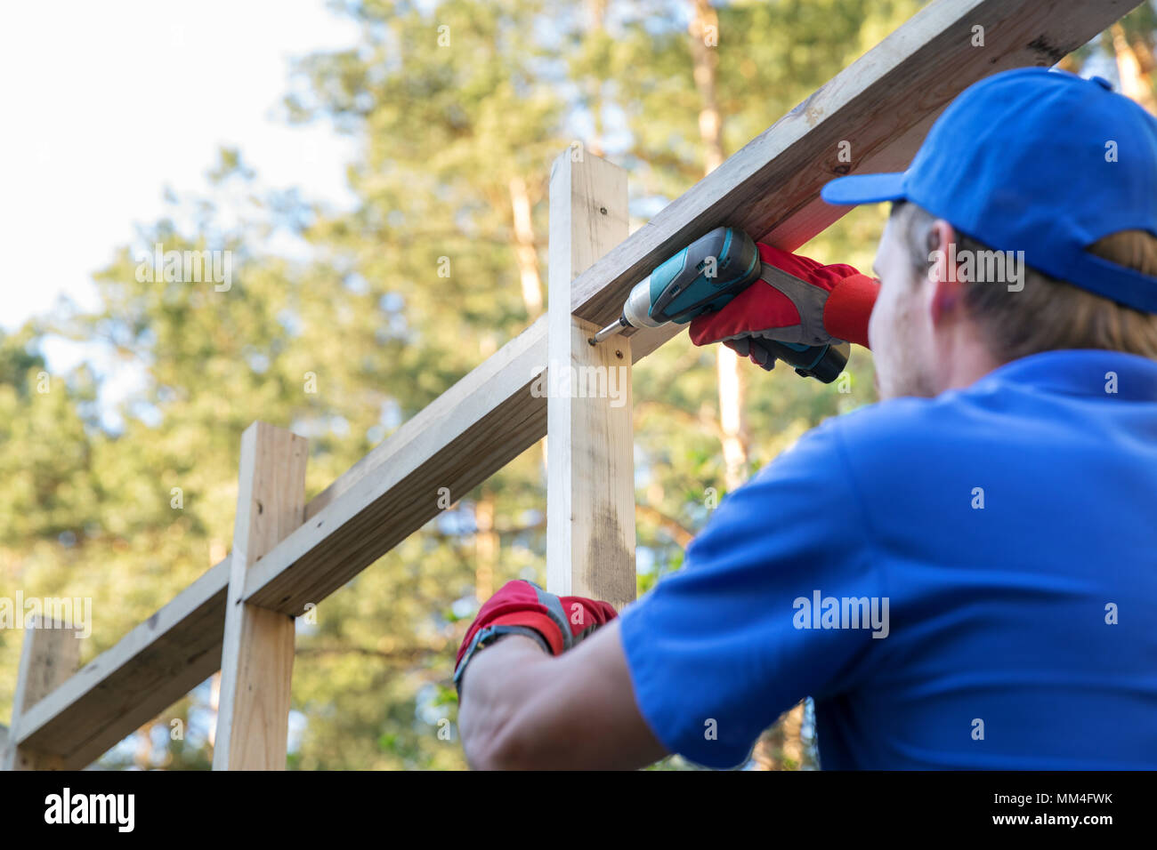 construction worker working on wooden house structure Stock Photo - Alamy