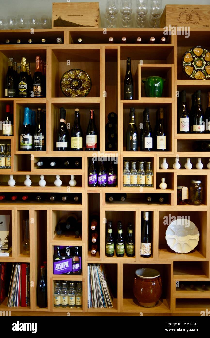 Stylish wood wall shelves displaying fine wines, gift items, plates and  cookbooks for sale, La Bergerie, artisanal market, Fredericksburg, Texas,  USA Stock Photo - Alamy