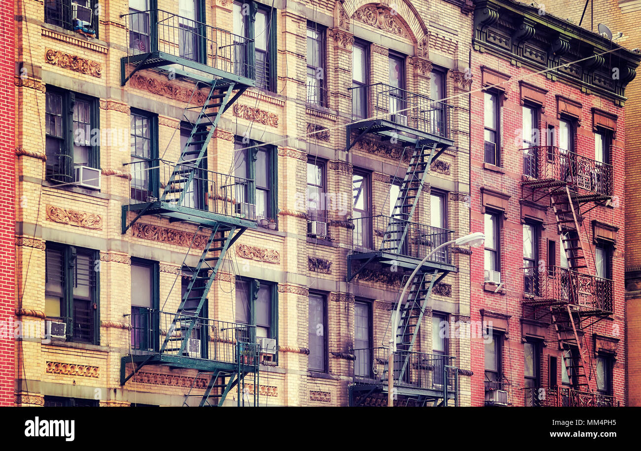Vintage stylized picture of old buildings with fire escapes, one of New ...