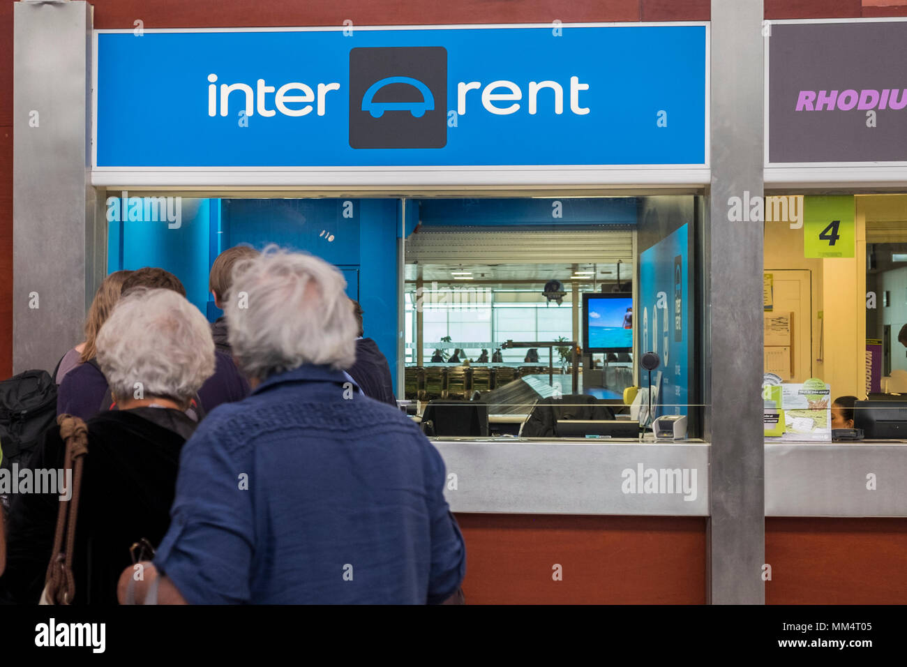 Queueing for car rental at the offices in the arrivals hall at Tenerife Sur, Reina Sofia, airport, Canary islands, Spain Stock Photo