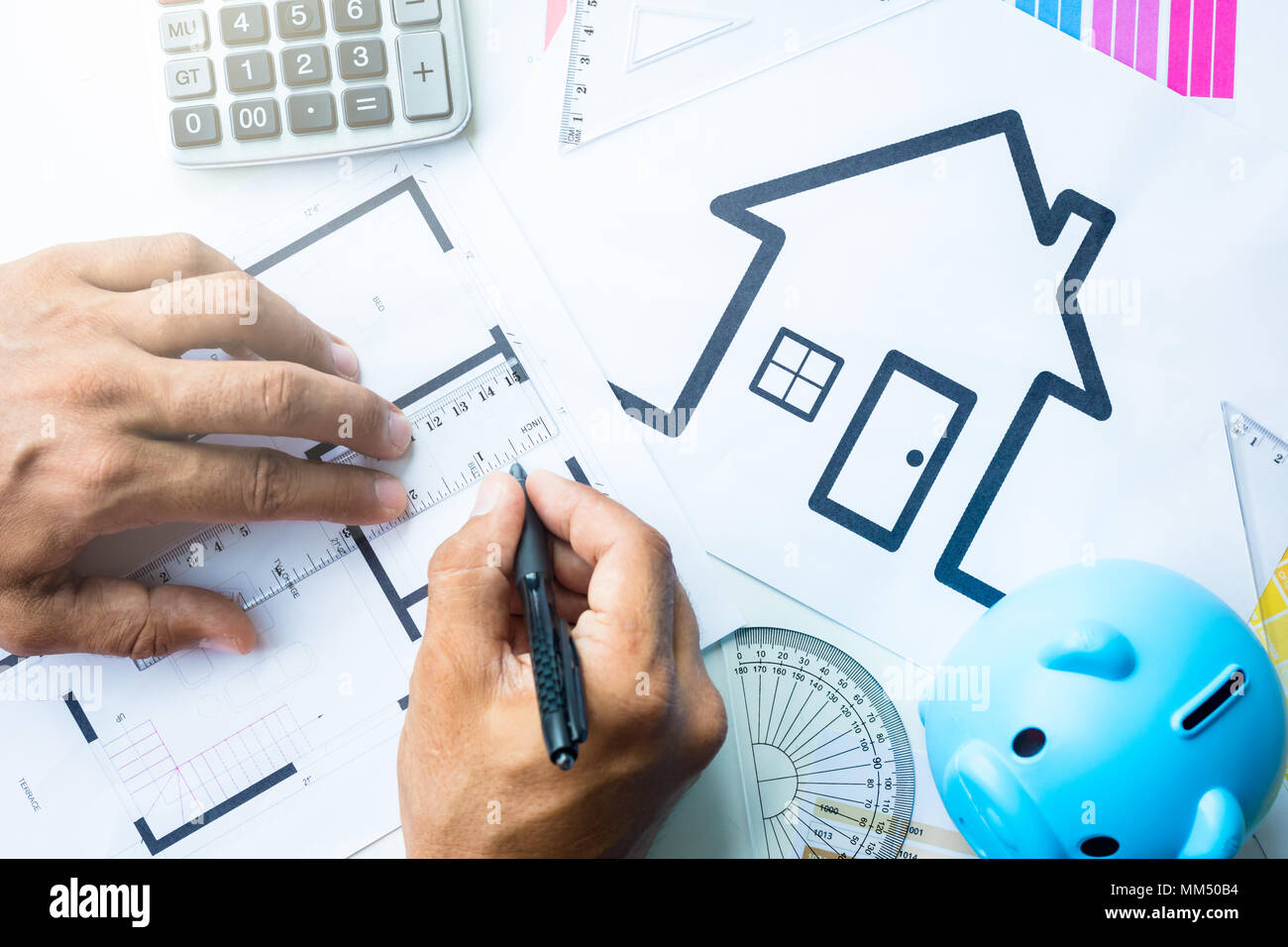 Business, architecture, building, construction concept - close up of architect working on blueprint . Stock Photo