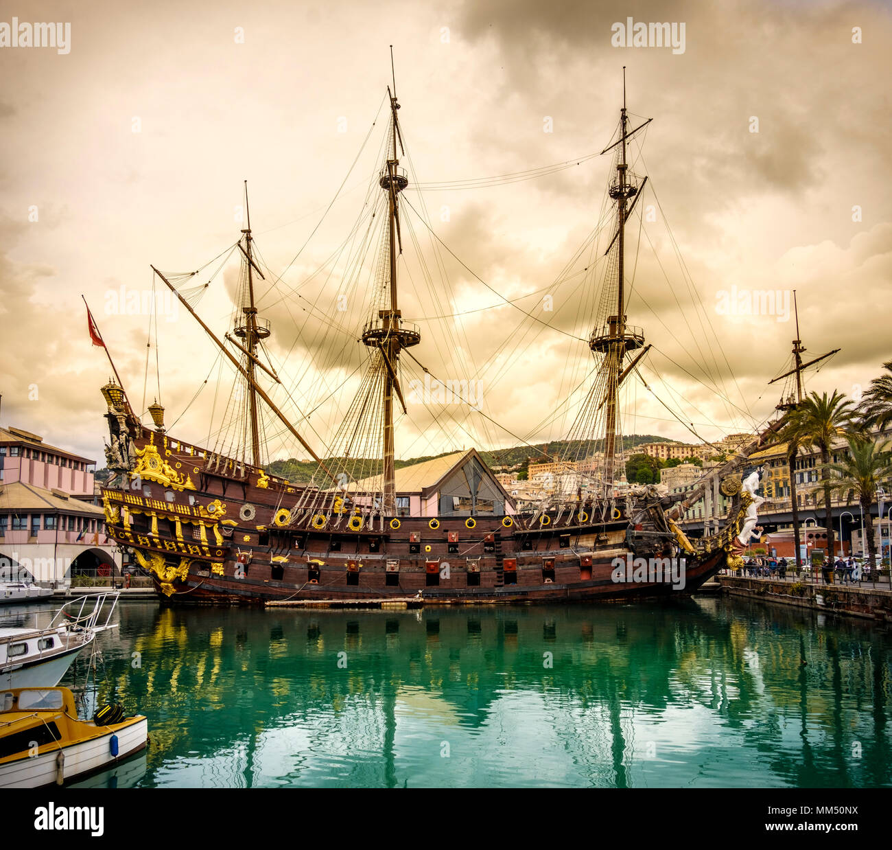pirate sailing ship galleon sailer Genoa port yellow storm cloudscape Liguria Italy Stock Photo