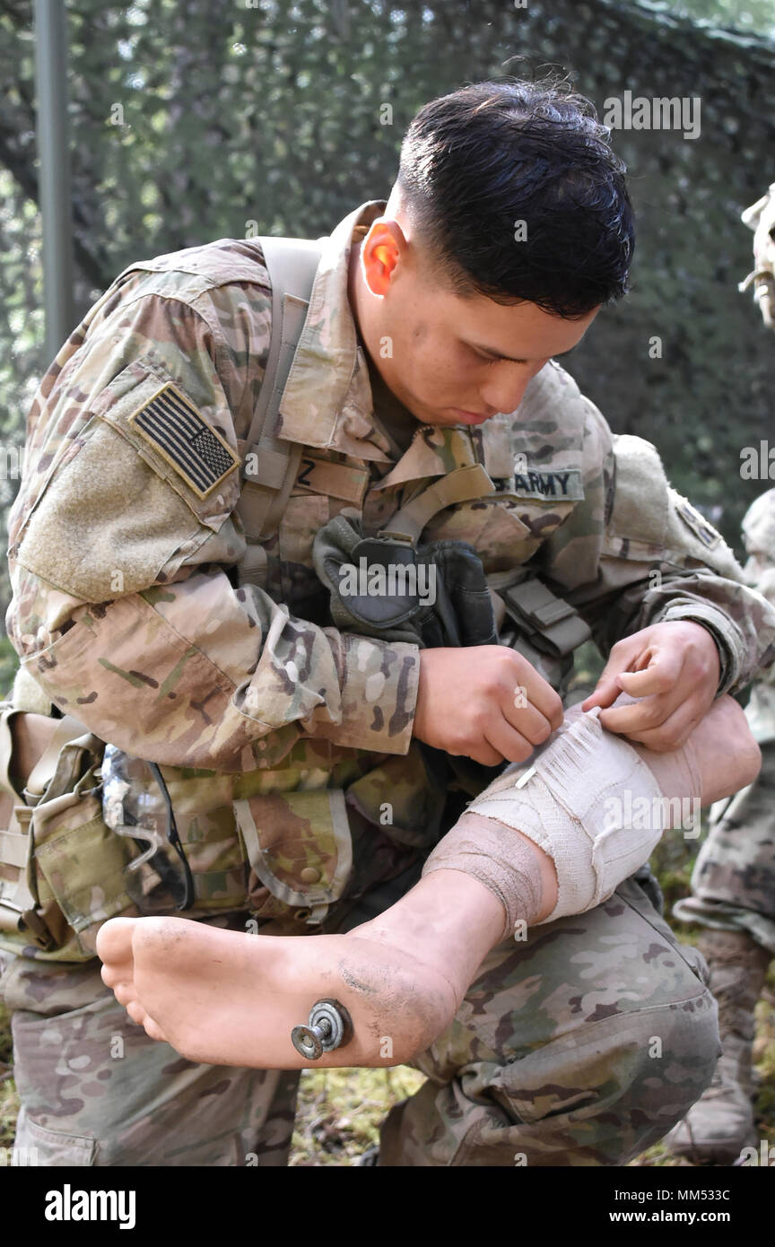 U.S. Army Pfc. Joel Perez with Headquarters and Headquarters Company, 1st Battalion, 68th Armor Regiment, 3rd Armored Brigade Combat Team, 4th Infantry Division, tests his medical skills during the 2nd Cavalry Regiment’s Expert Infantryman Badge competition training phase at the 7th Army Training Command’s Grafenwoehr Training Area, Germany, Sept. 6, 2017. (U.S. Army photo by Visual Information Specialist Gertrud Zach) Stock Photo