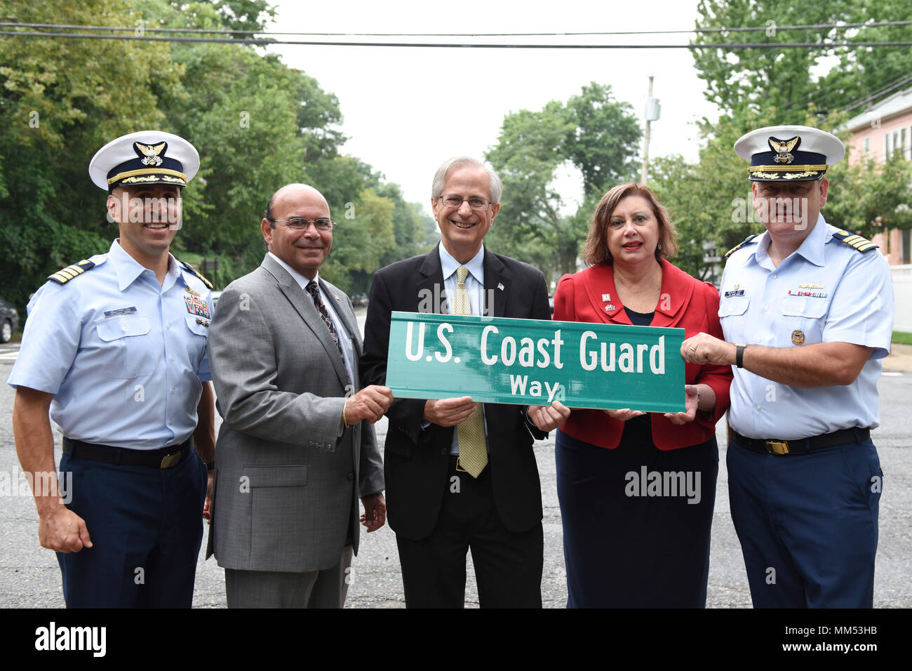 NEW YORK – Capt. Jason Tama, deputy commander Sector New York, stands with Frank Santarpia, senior advisor to the borough president, Ed Burke, deputy borough president, Linda Dianto, executive director National Lighthouse Museum, and Capt. Michael Day, commander Sector New York, as they hold a new street sign to be installed on Staten Island on Sept. 6, 2017. A portion of Bay Street near Fort Wadsworth is now renamed ‘U.S. Coast Guard Way.’ (U.S. Coast Guard photo by Petty Officer 3rd Class Steve Strohmaier) Stock Photo