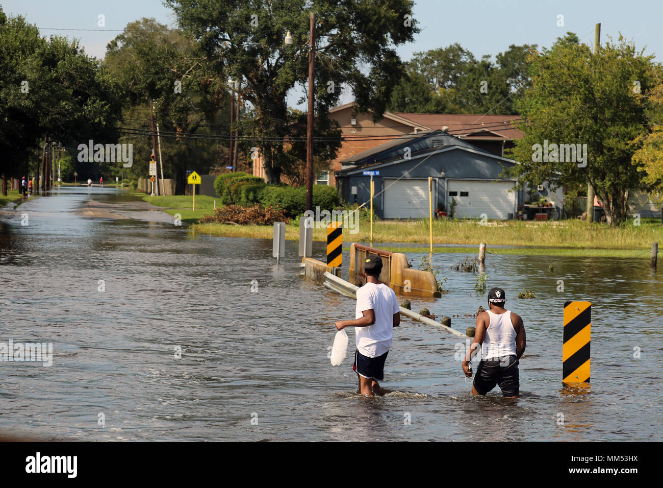 Locals walk the streets of a heavily flooded area in Orange, Texas. Sep., 5, 2017.  (U.S. Army photo by Spc. Hayley Gardner) Stock Photo