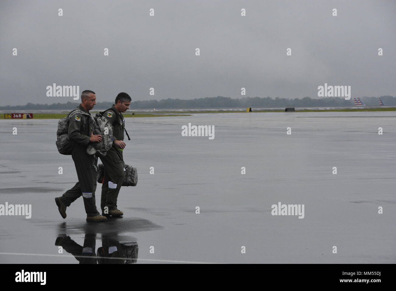 Two members of the 156th Aeromedical Evacuation Squadron of the North Carolina Air National Guard walk towards a C-130 for departure to Key West Florida to aid in medical evacuations prior to the arrival of Hurricane Irma, while at the North Carolina Air National Guard Base, Charlotte Douglass International Airport, Sept. 6, 2017. The guardsman assisted with the transfer of eleven patients from the Lower Keys Medical Center in Key West Florida, to the Gadsden Alabama Regional Medical Center. Stock Photo