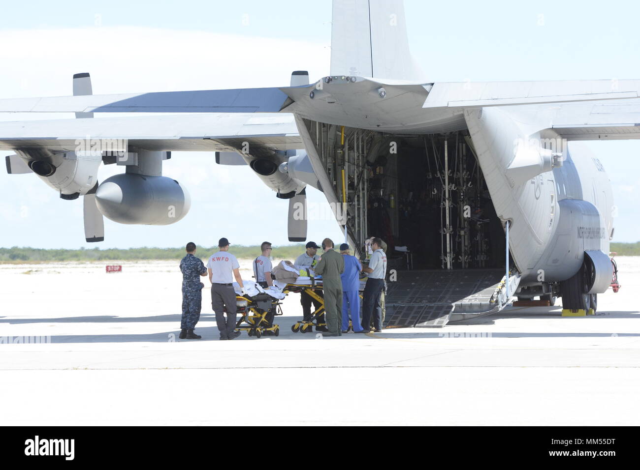 A patient from the Lower Keys Medical Center in Florida is loaded onto a North Carolina Air National Guard C-130 that arrived to assist with evacuation efforts prior to the arrival of Hurricane Irma, while at the Key West Naval Air Station, Key West Florida, Sept. 6, 2017. The patients were evacuated prior to the arrival of Hurricane Irma, a category five storm that is expected to cause catastrophic damage to the regions it makes landfall. The 156th Aeromedical Evacuation Squadron of the North Carolina Air National Guard provides medical care for wounded individuals while transporting them to  Stock Photo