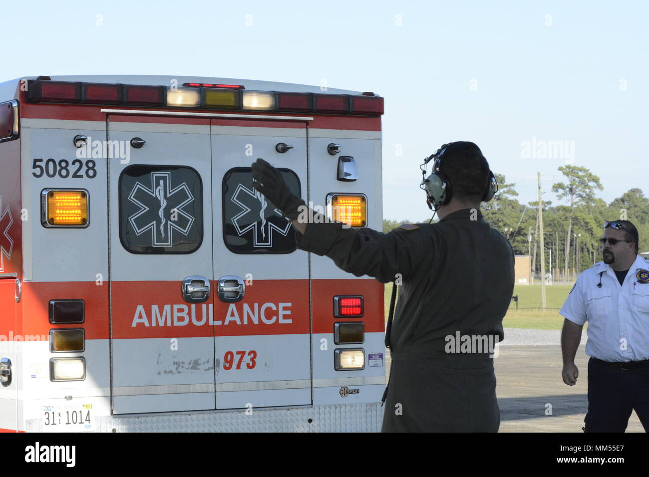 A member of the 156th Aeromedical Evacuation Squadron guides an ambulance belonging to first responders from the Gadsden Alabama Fire Department to the back of a C-130 Hercules carrying patients evacuated from Key West Florida, while at the Northeast Alabama Regional Airport, Gadsden Alabama, Sept. 6, 2017. The patients were evacuated prior to the arrival of Hurricane Irma, a category five storm that is expected to cause catastrophic damage to the regions it makes landfall. The 156th Aeromedical Evacuation Squadron of the North Carolina Air National Guard provides medical care for wounded indi Stock Photo